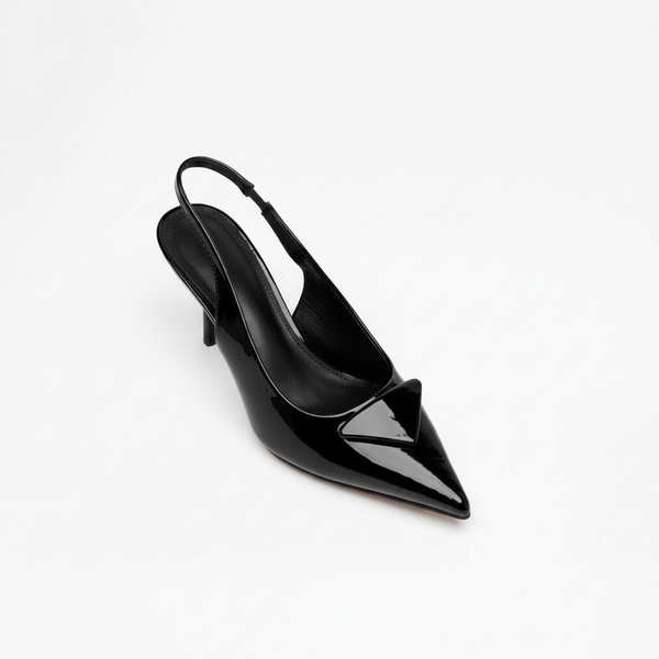 Black patent stiletto slingback shoe on a white studio background